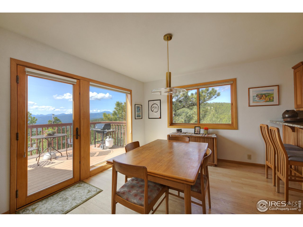 493 Sky Trail Road Boulder, CO 80302 - Photo 11 of 40 a view of a dining room with furniture window and wooden floor