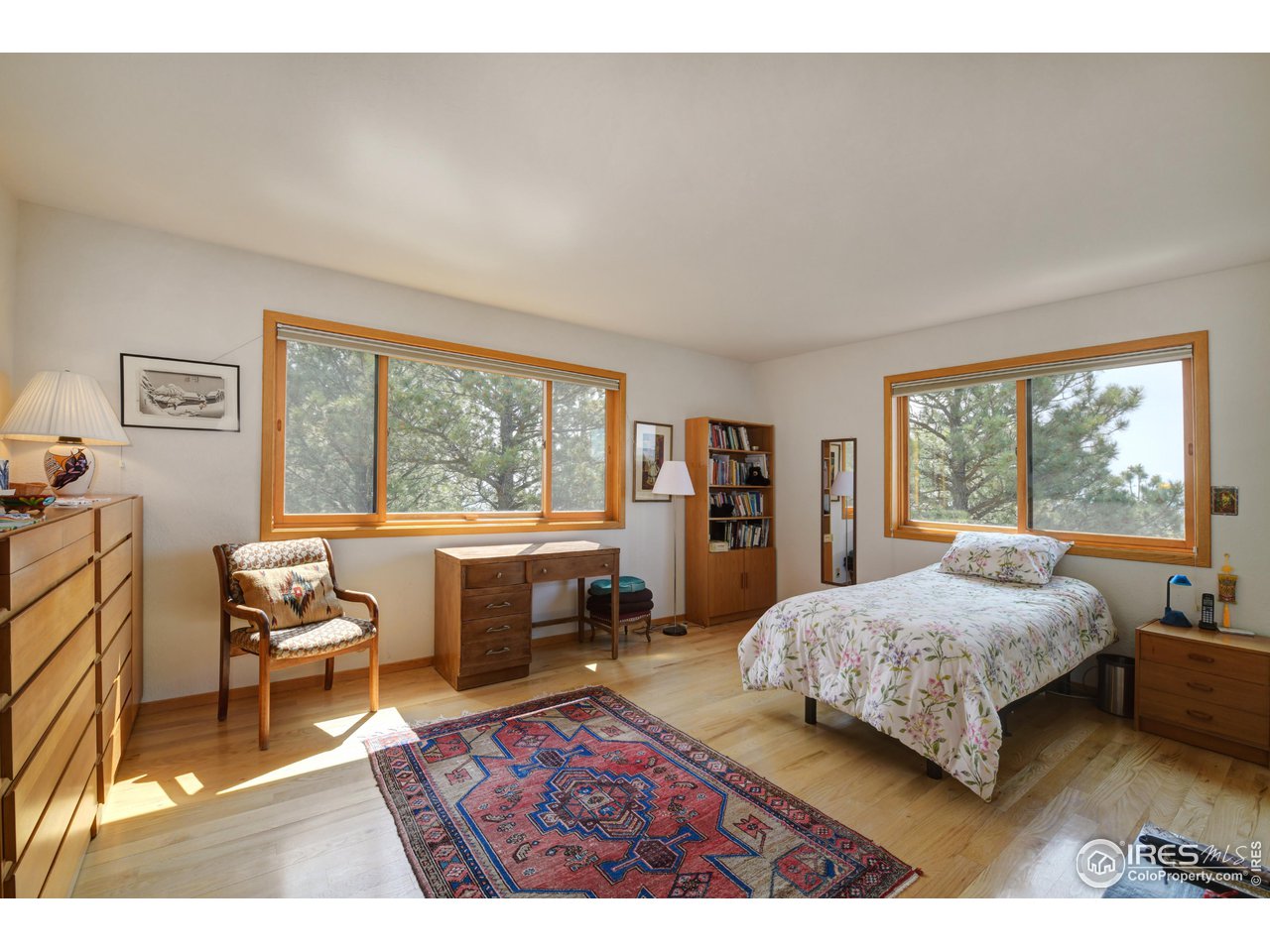 493 Sky Trail Road Boulder, CO 80302 - Photo 20 of 40 a bedroom with a bed and a large window