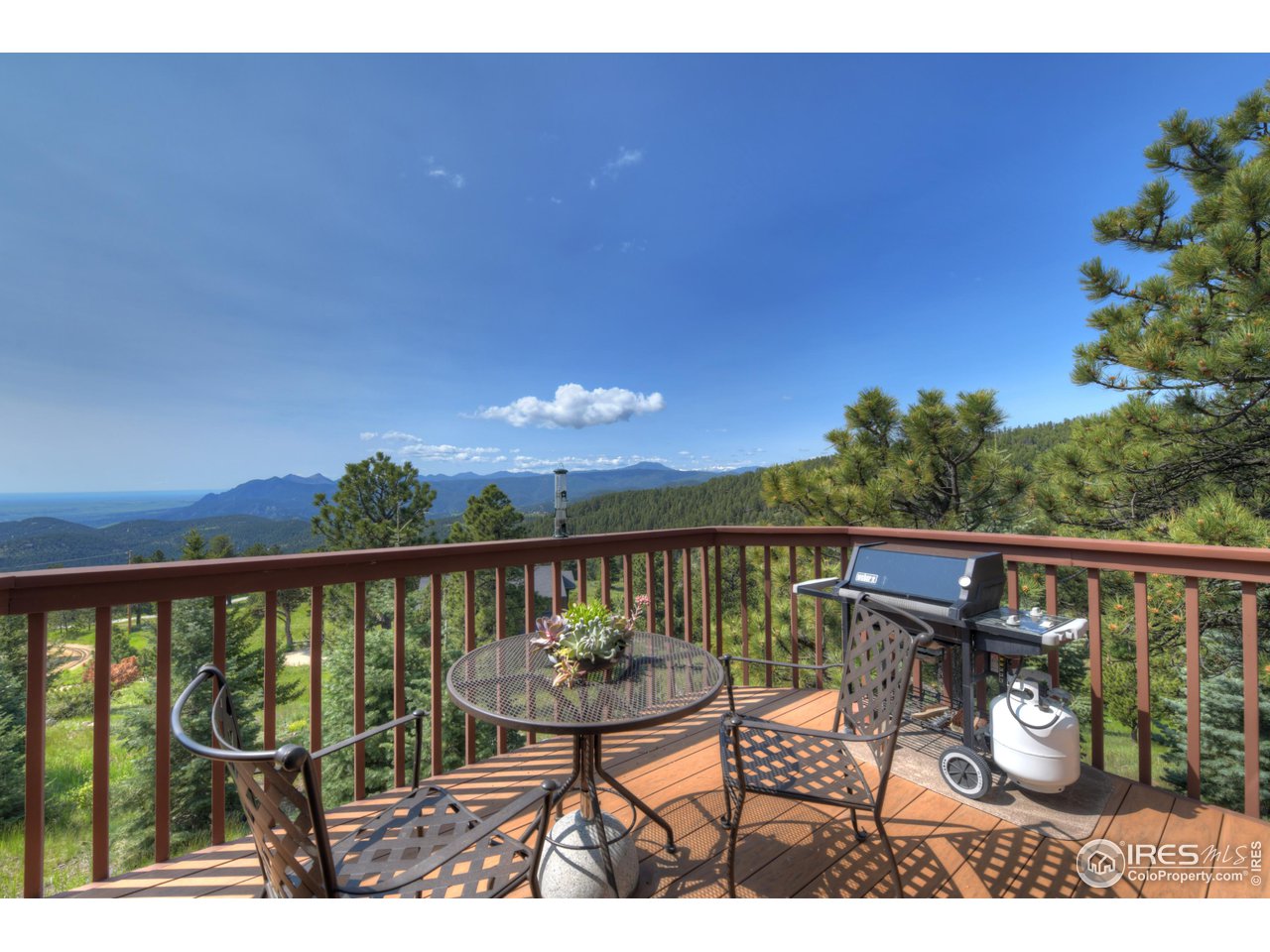 493 Sky Trail Road Boulder, CO 80302 - Photo 2 of 40 a view of a balcony with wooden floor and outdoor seating