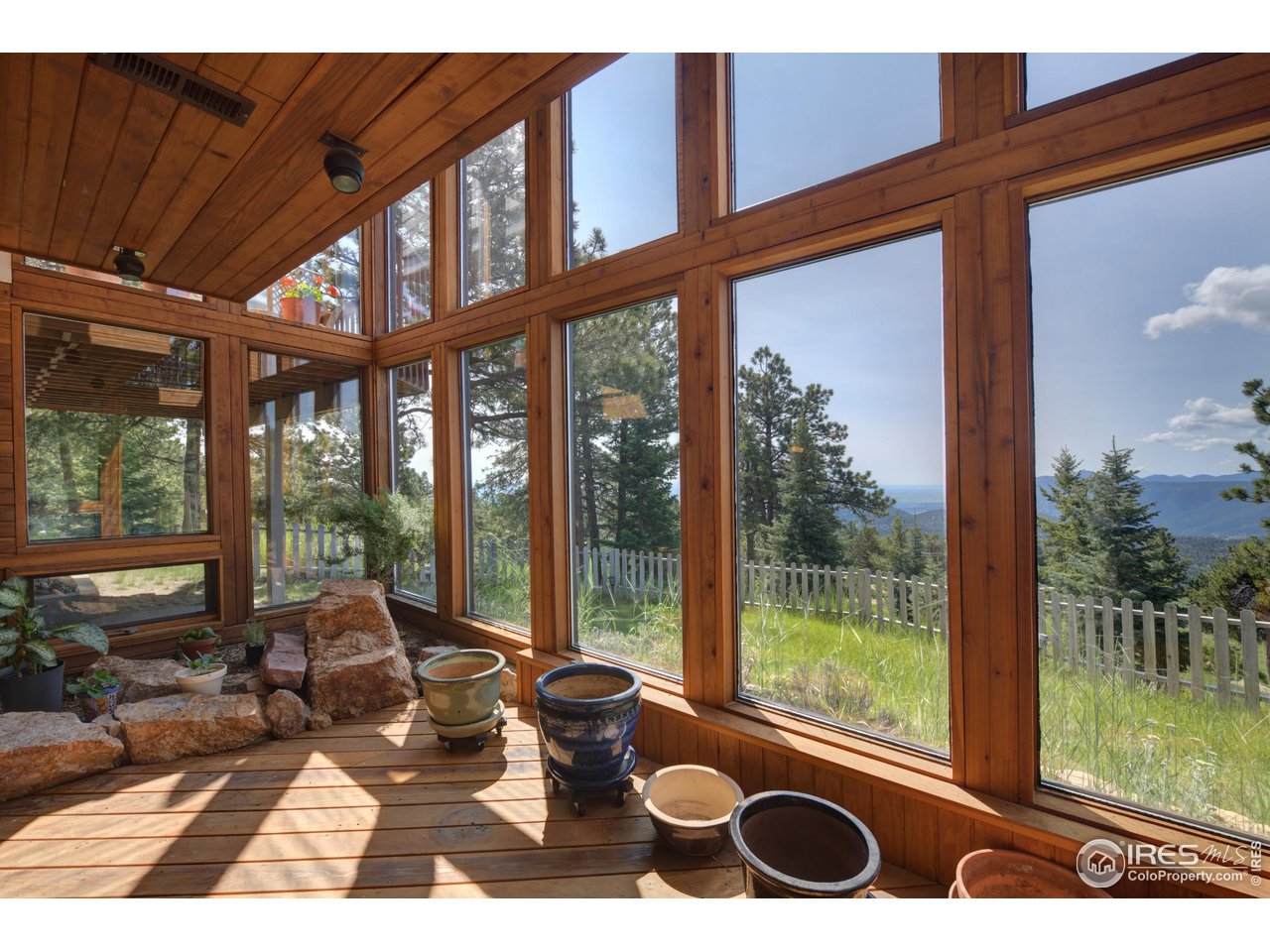 493 Sky Trail Road Boulder, CO 80302 - Photo 24 of 40 a view of a room with wooden floor and floor to ceiling windows