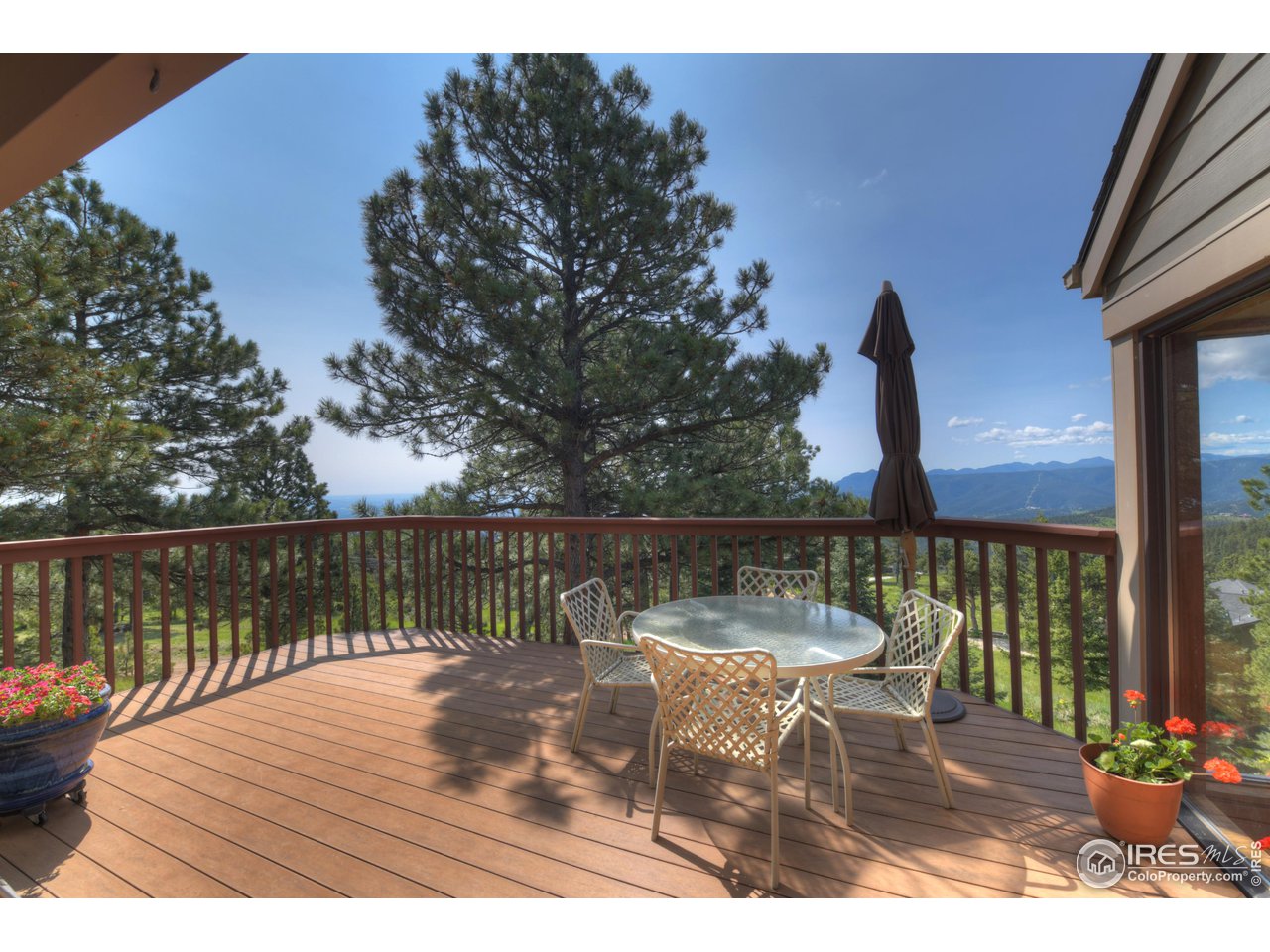 493 Sky Trail Road Boulder, CO 80302 - Photo 32 of 40 a view of a balcony with wooden floor and outdoor seating