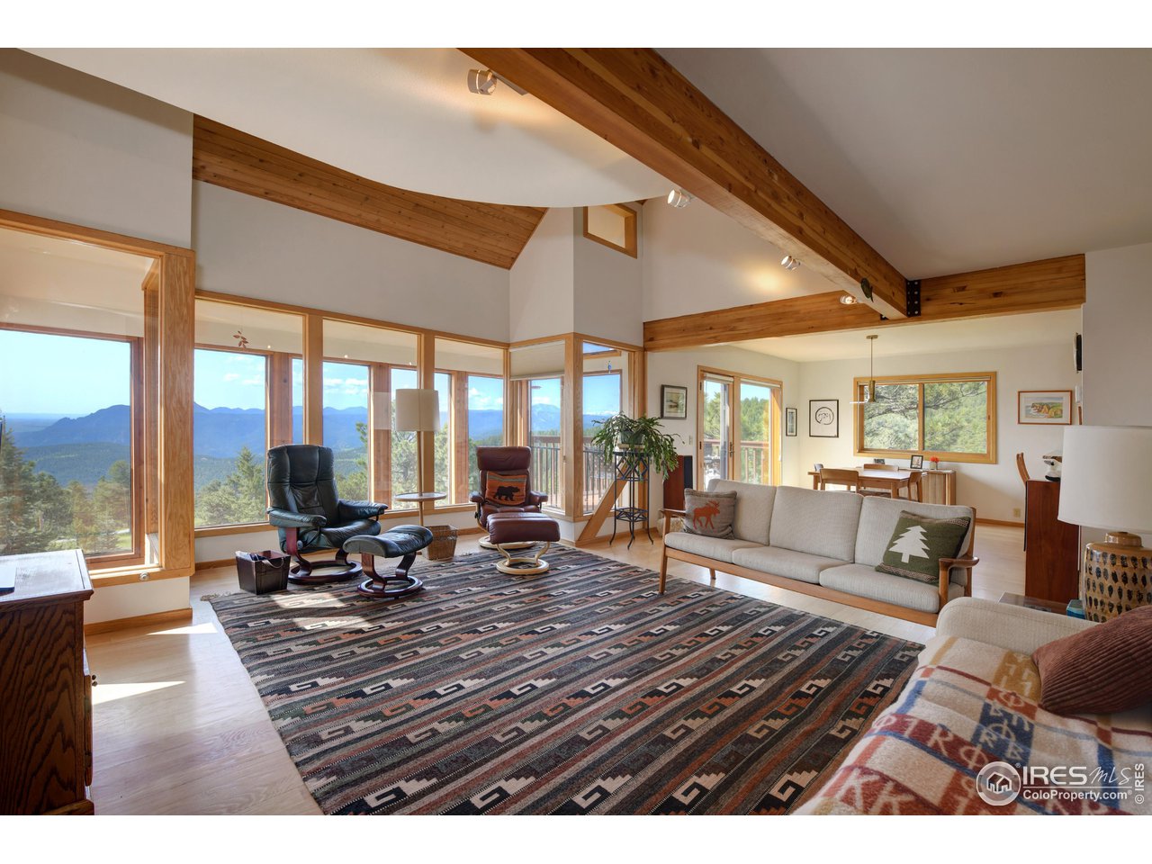493 Sky Trail Road Boulder, CO 80302 - Photo 4 of 40 a living room with furniture water view and large windows