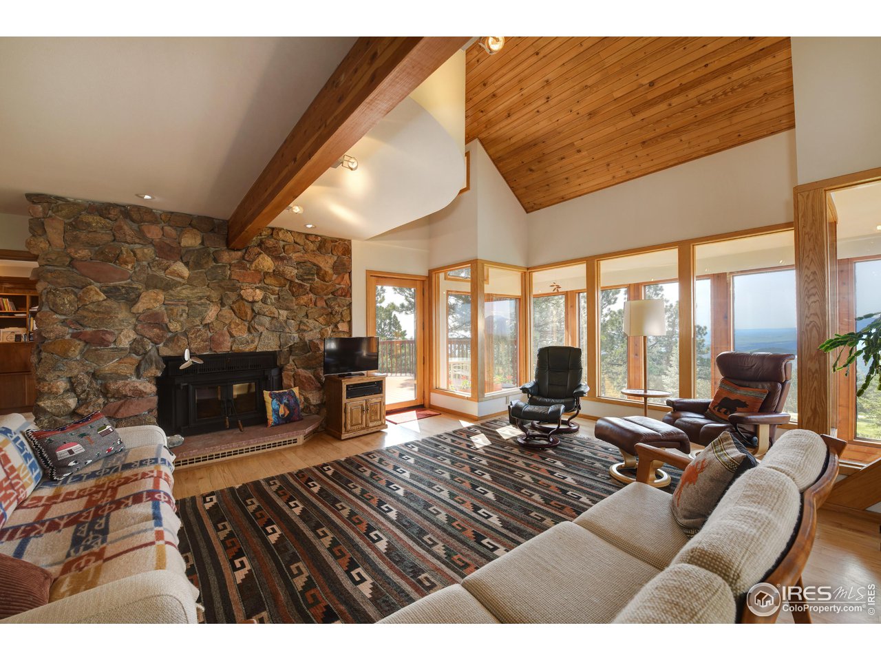 493 Sky Trail Road Boulder, CO 80302 - Photo 5 of 40 a living room with furniture large window and flat screen tv