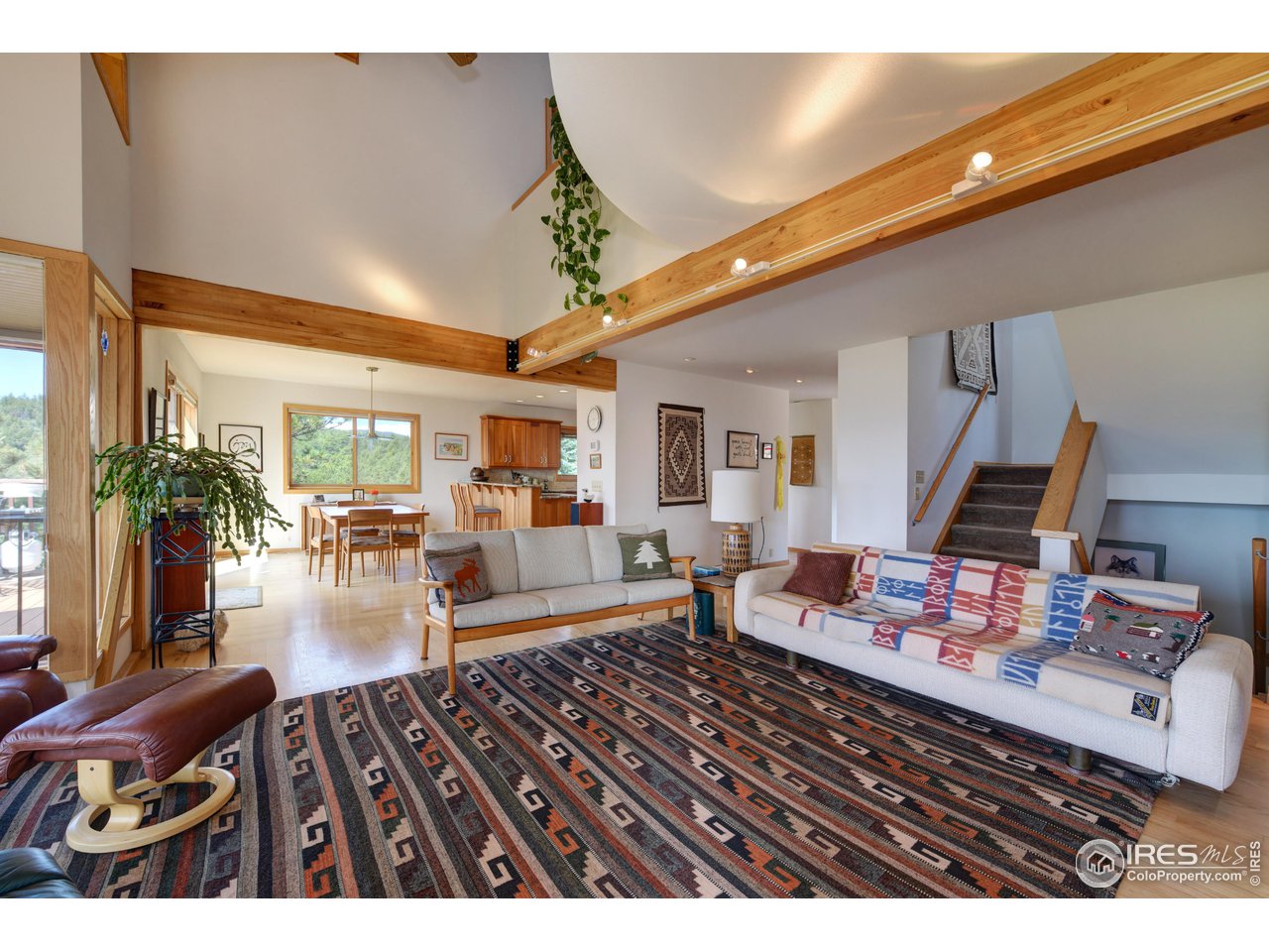 493 Sky Trail Road Boulder, CO 80302 - Photo 6 of 40 a living room with furniture and a chandelier