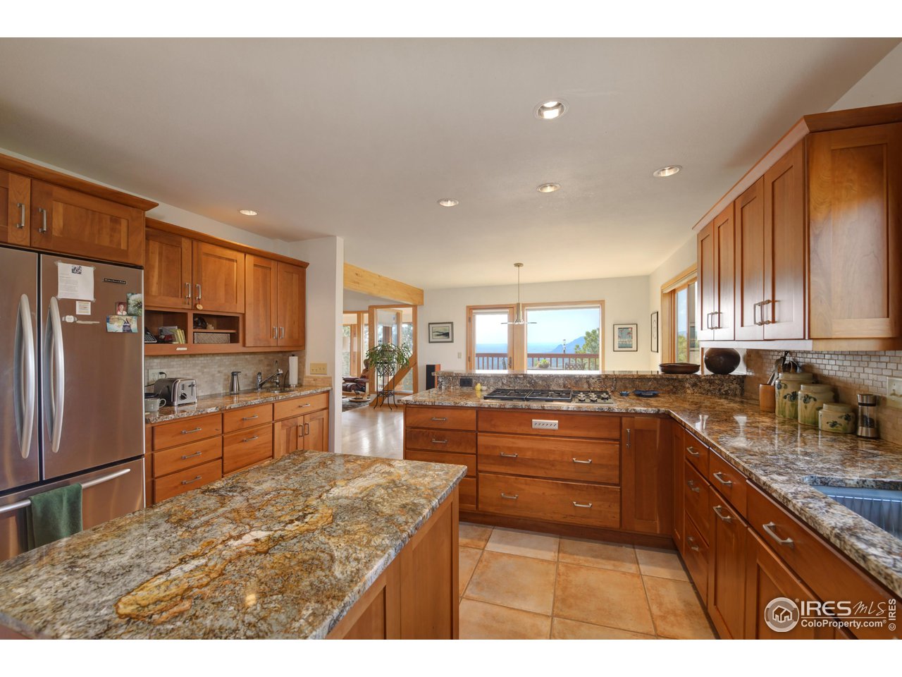 493 Sky Trail Road Boulder, CO 80302 - Photo 9 of 40 a kitchen with stainless steel appliances granite countertop a sink stove and refrigerator
