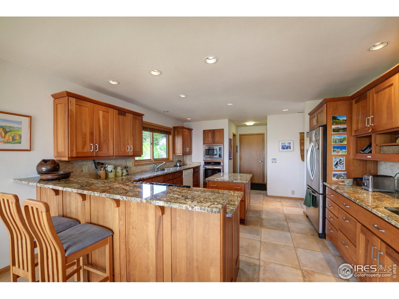 493 Sky Trail Road Boulder, CO 80302 - Photo 10 of 40 a kitchen with stainless steel appliances granite countertop a sink and cabinets
