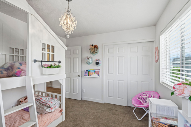 7685 Timber Country Road Eagle Mountain, UT 84005 - Photo 22 of 39 White paneled walls and carpeted flooring define this room, featuring a double-pane window with white blinds