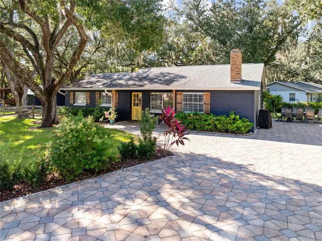 a backyard of a house with table and chairs