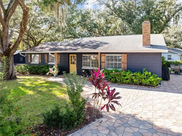 a kitchen view with stainless steel appliances furniture cabinets and wooden floor
