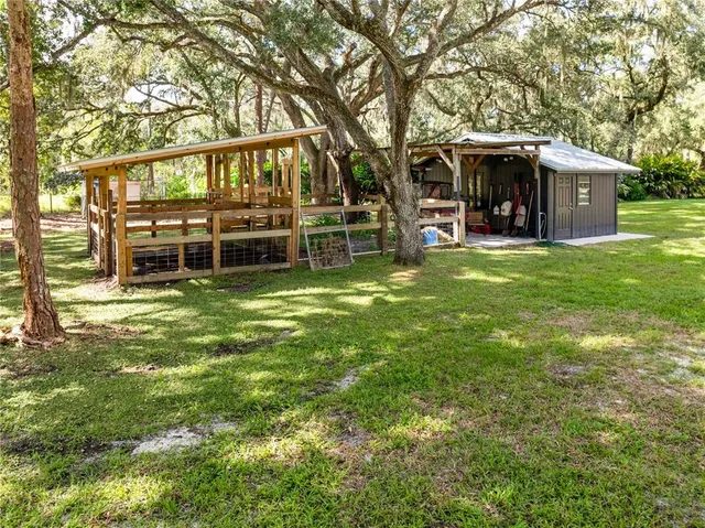 a view of a house with a backyard porch and sitting area