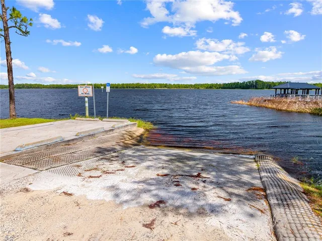 a view of a lake with beach and city