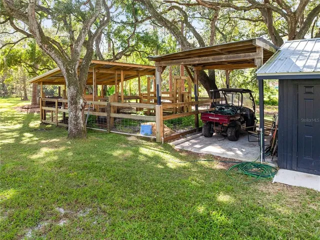 a view of a house with backyard porch and sitting area