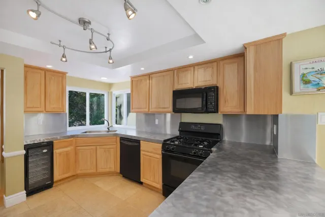 a kitchen with a stove a sink and a microwave