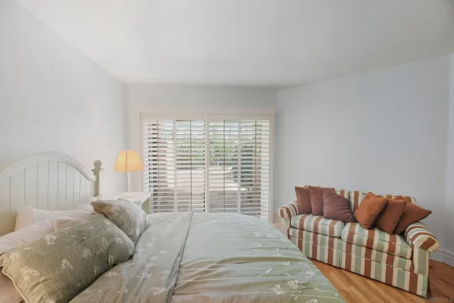 a bathroom with a granite countertop sink a toilet and a mirror