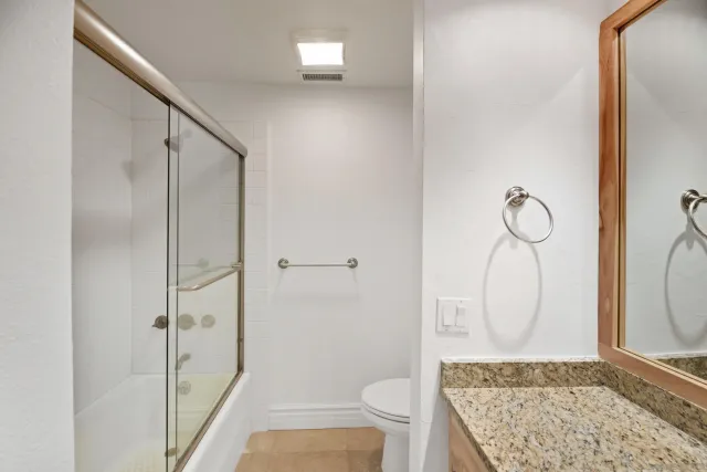 a bedroom with a large bed and a couch