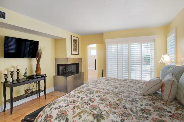 a spacious bedroom with a large bed and a flat screen tv