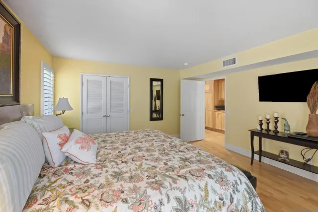 a bedroom with a bed and a television