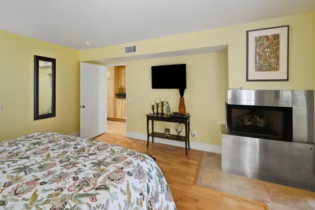 a bathroom with a granite countertop sink mirror and bathtub