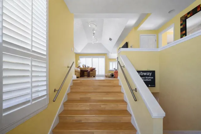 a view of entryway and hall with wooden floor