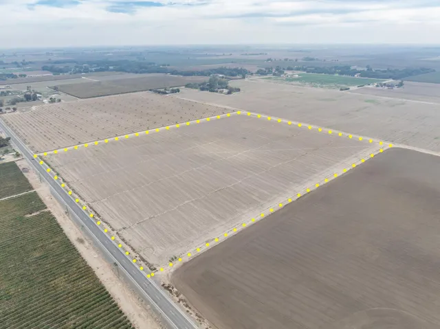 an aerial view of a house with a yard and lake view