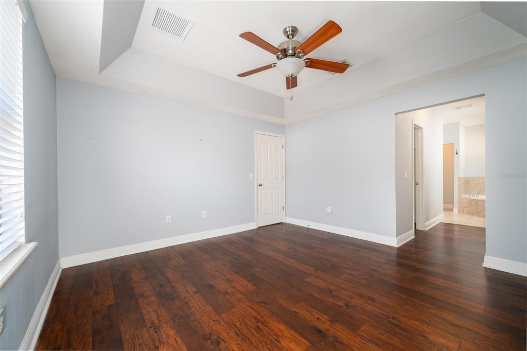 7931 Southwest 88th Street Gainesville, FL 32608 - Photo 17 of 35 an empty room with wooden floor and windows