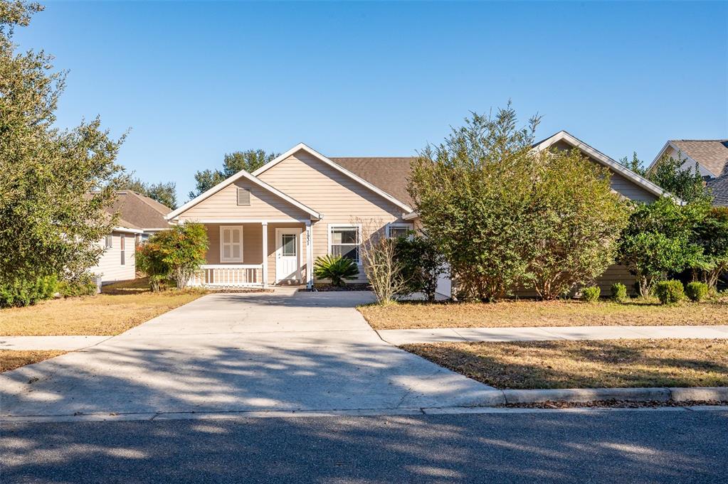 7931 Southwest 88th Street Gainesville, FL 32608 - Photo 2 of 35 a front view of a house with a yard and garage