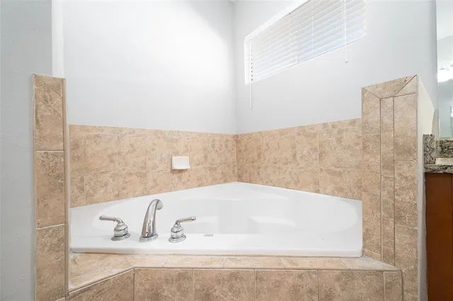 a bathroom with bathtub and shower