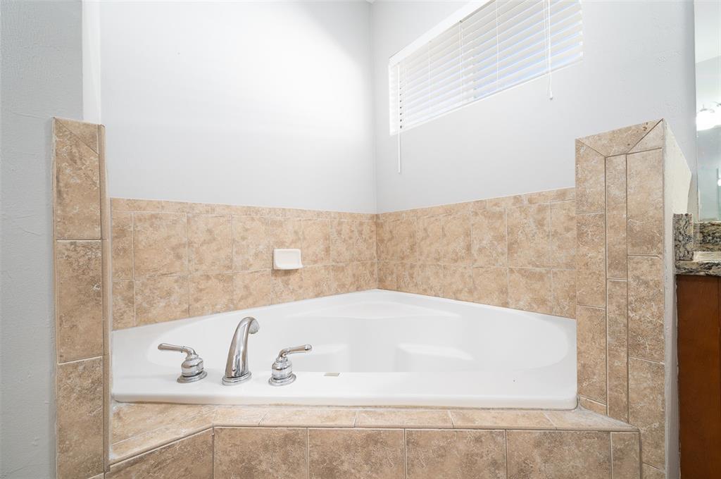 7931 Southwest 88th Street Gainesville, FL 32608 - Photo 21 of 35 a bathroom with bathtub and shower