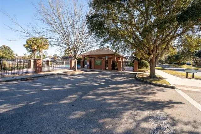 a front view of a building with large trees