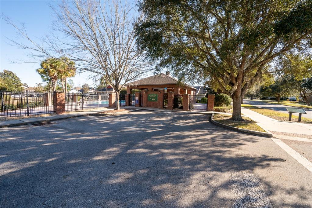 7931 Southwest 88th Street Gainesville, FL 32608 - Photo 31 of 35 a front view of a building with large trees