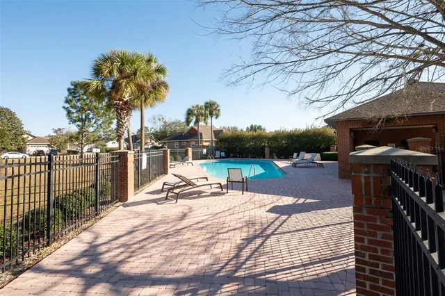 a view of a house with backyard and sitting area