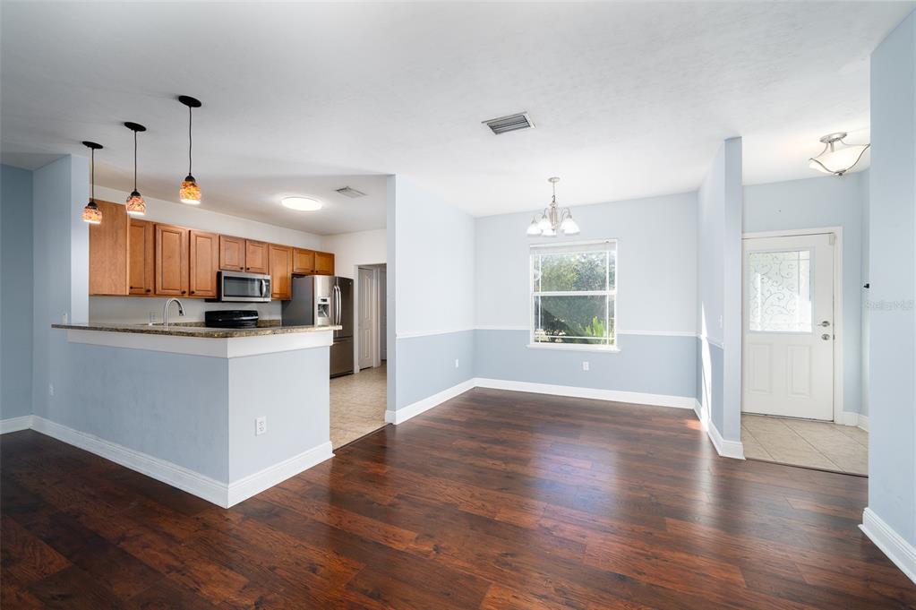 7931 Southwest 88th Street Gainesville, FL 32608 - Photo 8 of 35 a view of kitchen with cabinets and wooden floor