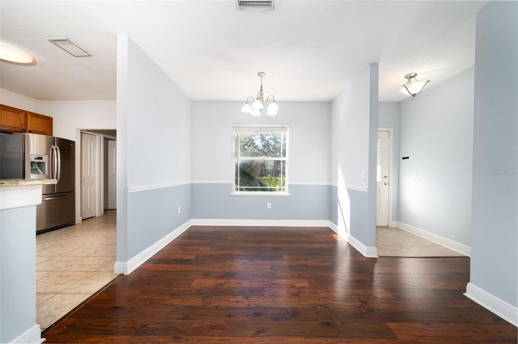 7931 Southwest 88th Street Gainesville, FL 32608 - Photo 9 of 35 a view of an empty room with window and wooden floor