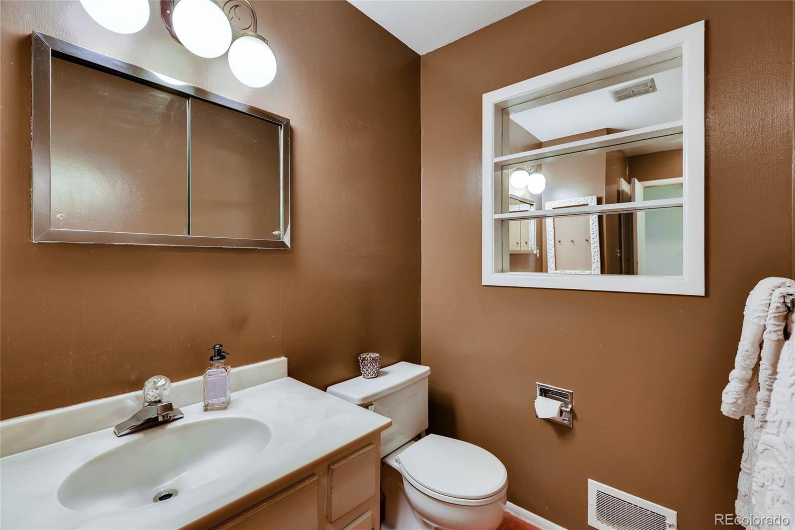 859 South Hudson Street Denver, CO 80246 - Photo 19 of 34 a bathroom with a sink mirror and toilet