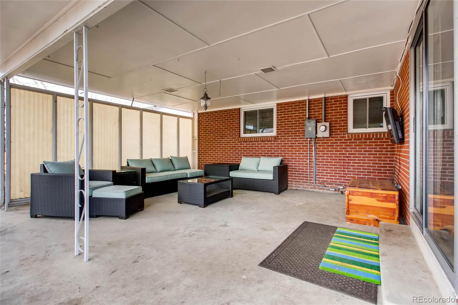 859 South Hudson Street Denver, CO 80246 - Photo 27 of 34 a backyard of a house with couches table and chairs