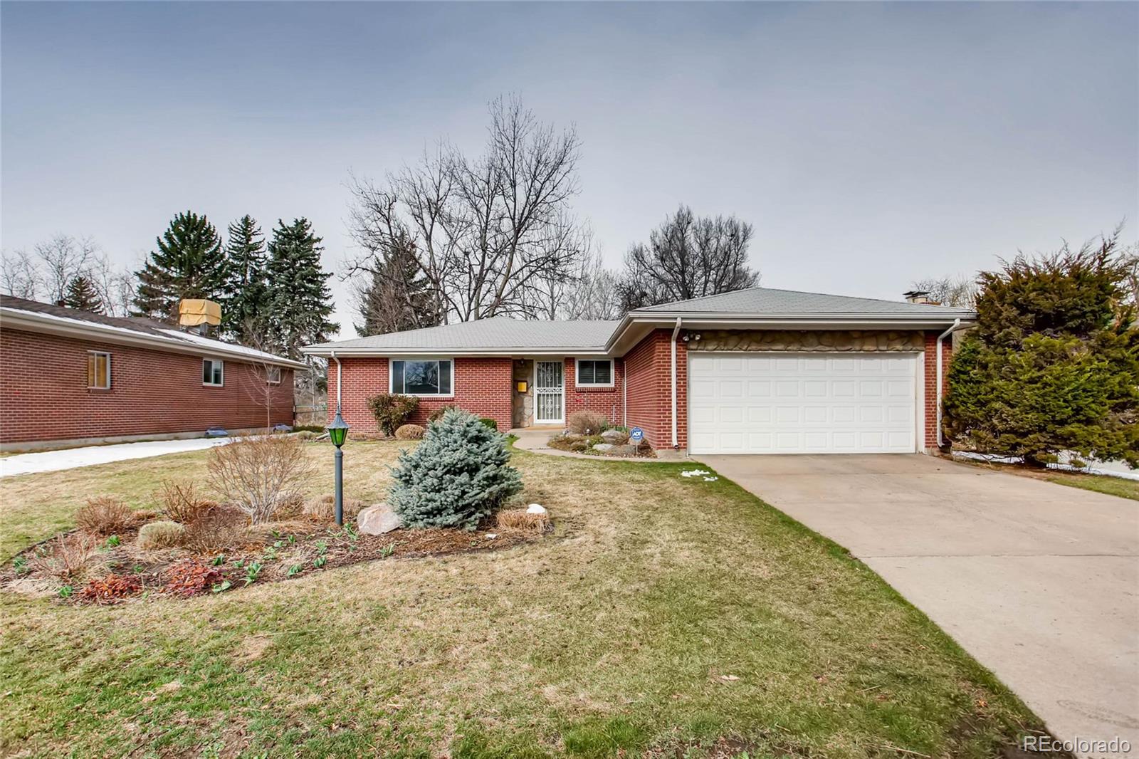 859 South Hudson Street Denver, CO 80246 - Photo 3 of 34 a front view of a house with a yard and garage