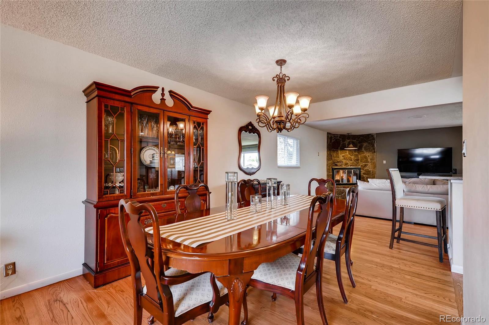 859 South Hudson Street Denver, CO 80246 - Photo 7 of 34 a dining room with furniture a chandelier and wooden floor