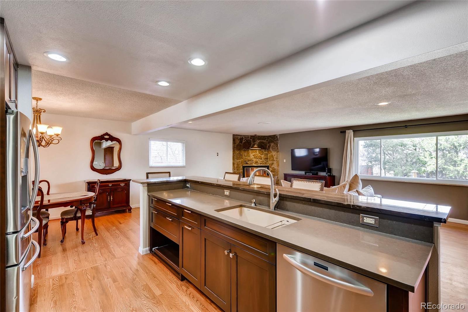 859 South Hudson Street Denver, CO 80246 - Photo 10 of 34 a kitchen with stainless steel appliances granite countertop a sink a stove and a wooden floors