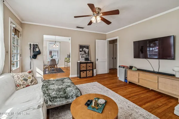 a view of a workspace with furniture and wooden floor