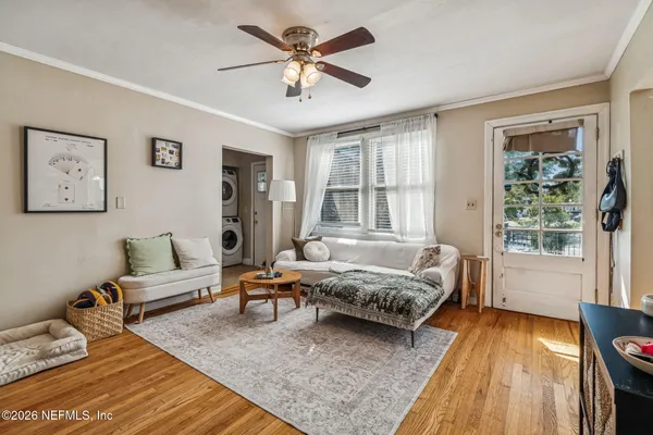 a spacious bedroom with a bed and a chandelier