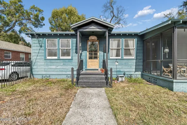 a view of a door of a house and a small yard