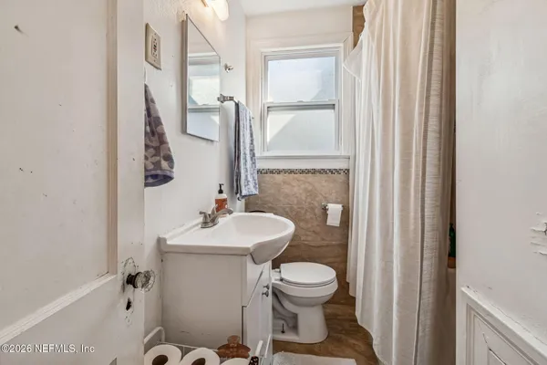 a bedroom with furniture and a wooden floor