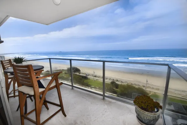 a view of a chairs and table in the balcony