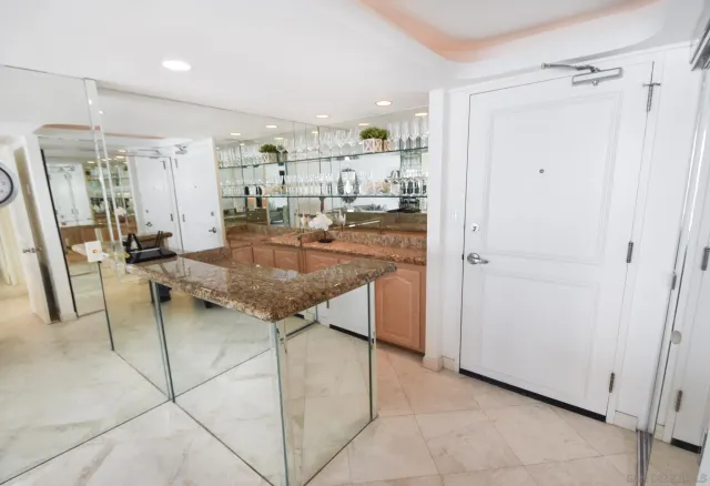 a view of a kitchen with kitchen island granite countertop wooden cabinets and counter space