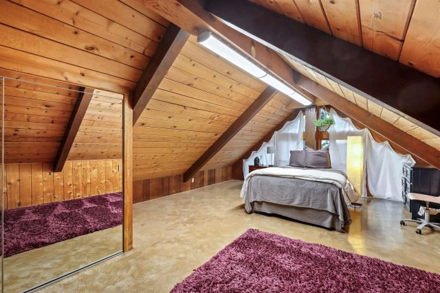 a bedroom with furniture and a window