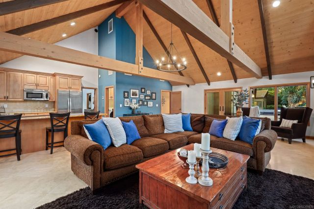 a living room with furniture a ceiling fan and a rug