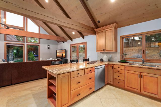 a kitchen with sink stove and cabinets