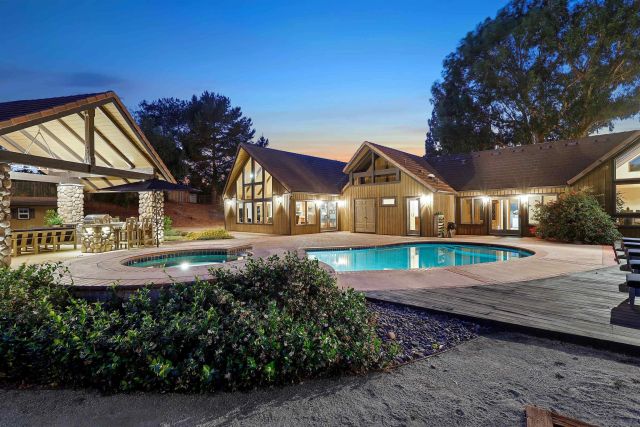 a view of an house with backyard space and balcony