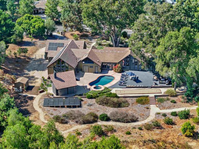 a view of a house with a yard and sitting area
