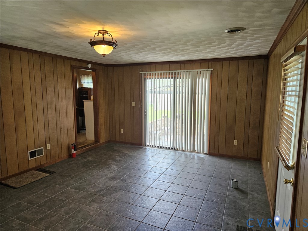 13336 Ladysmith Road Ruther Glen, VA 22580 - Photo 11 of 27 Spare room with wood walls and crown molding